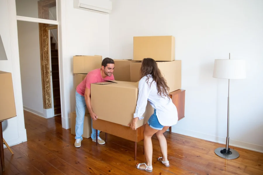 young-family-couple-moving-into-new-apartment-carrying-carton-boxes-furniture_74855-10466.jpg